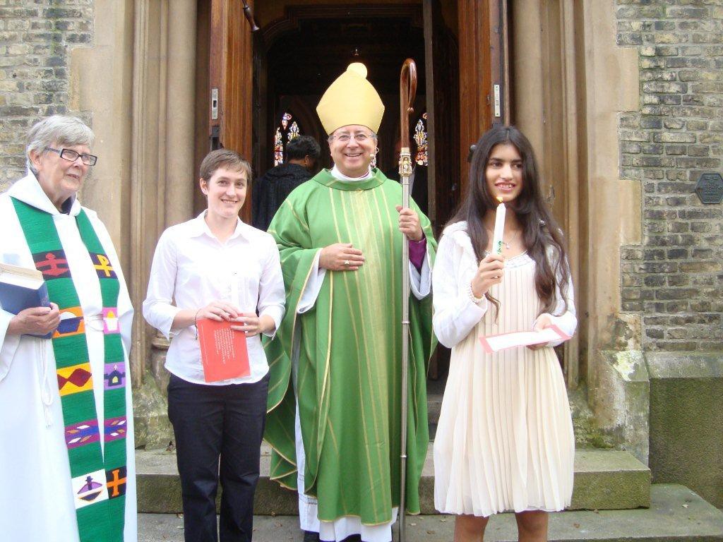 Bishop David with two Confirmation candidates after the service in 2011-